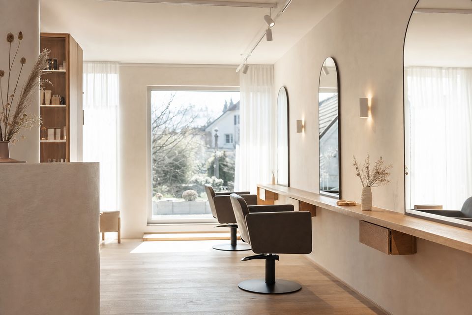 the room seen from a different angle, detail of the working area, chairs and mirrors, no people